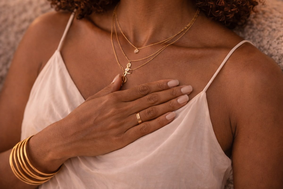 Hand over heart moment supporting abundance without forcing through calm presence