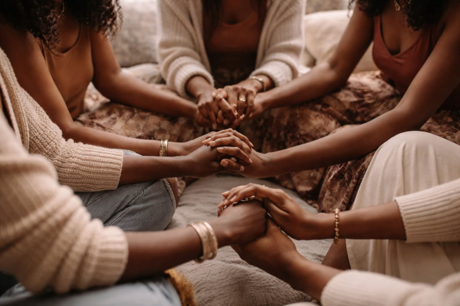 support circle for Black women holding hands together in a circle