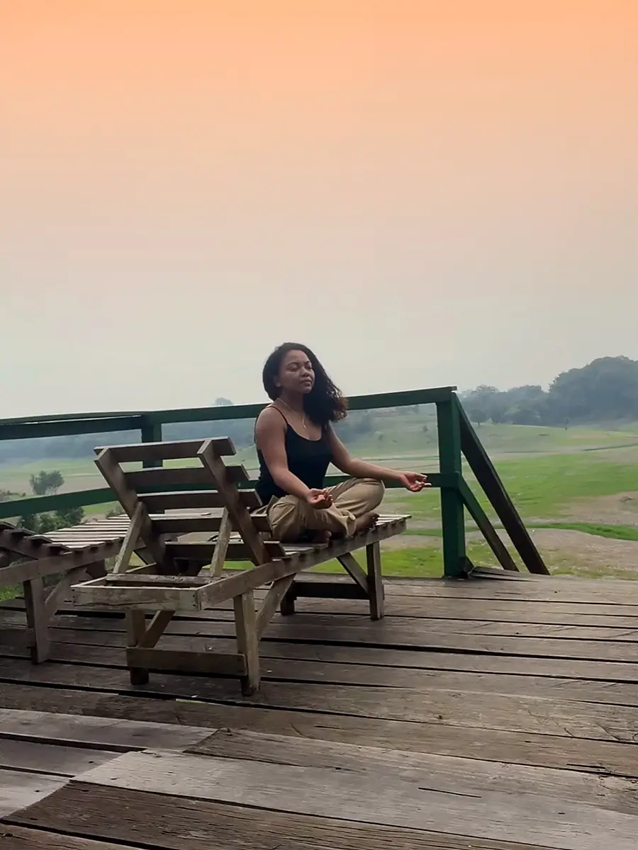 woman meditating in the Amazon forest during sunset